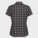 A short-sleeve collared button-up shirt with a black background and an all-over repeating pattern of white stylized faces and small pink hearts, shown on a plain white background.
